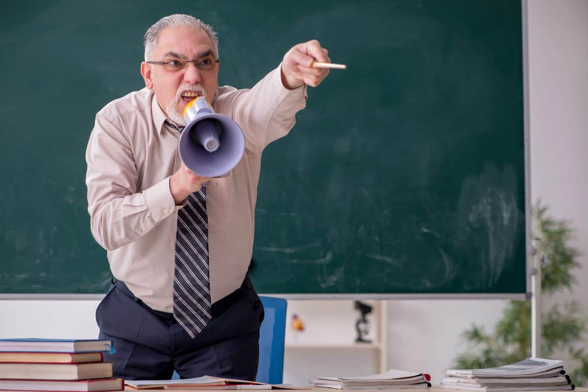 Old male teacher in the classroom