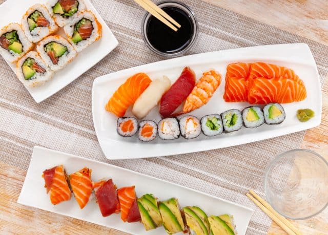 Closeup of colorful fresh sushi with wasabi and soy sauce on a plate in a japanese restaurant