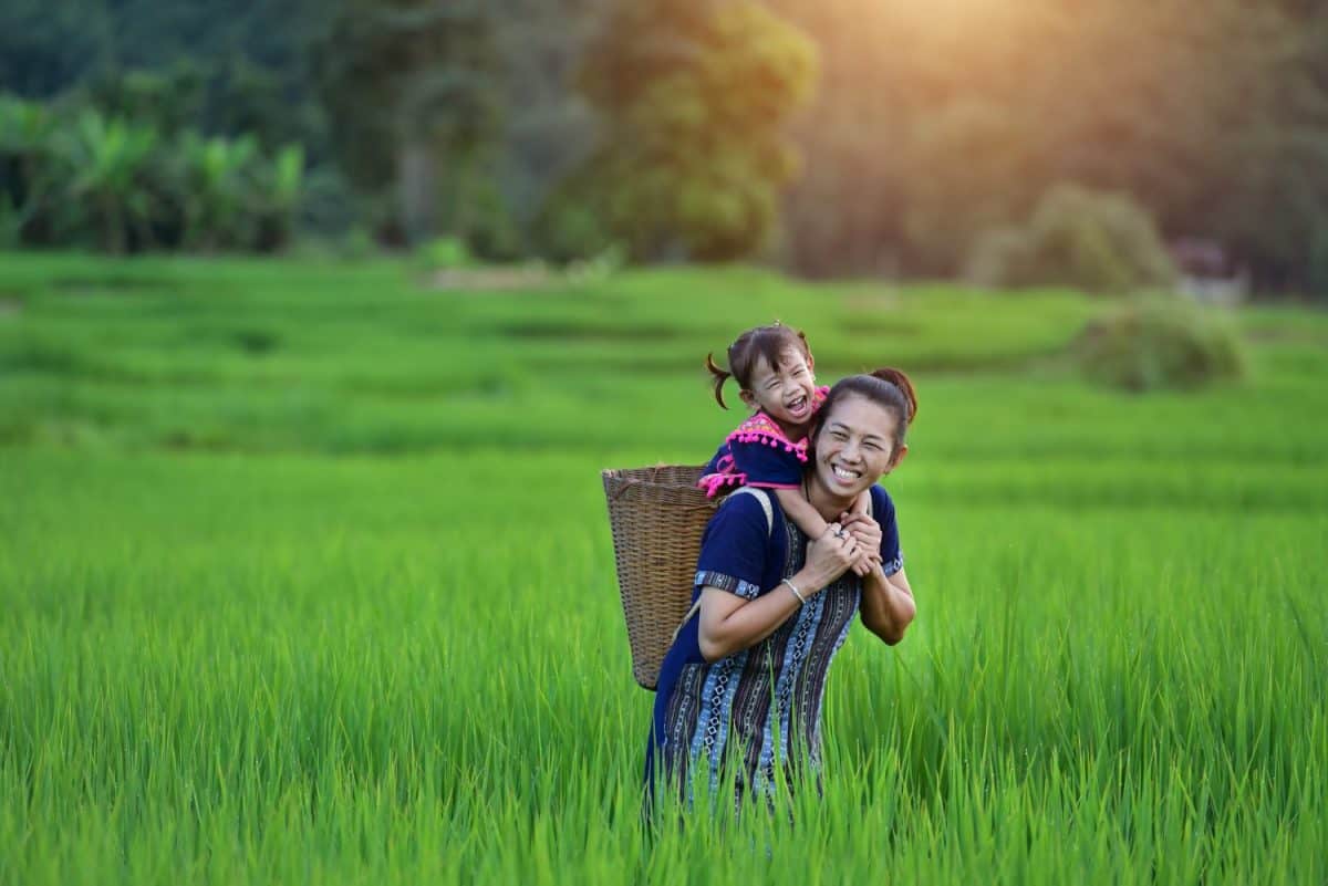 Happy Hmong women and smiling children sit outside at Giang Ta Chai village, close to Sapa town, Lao Cai province, northern Vietnam.