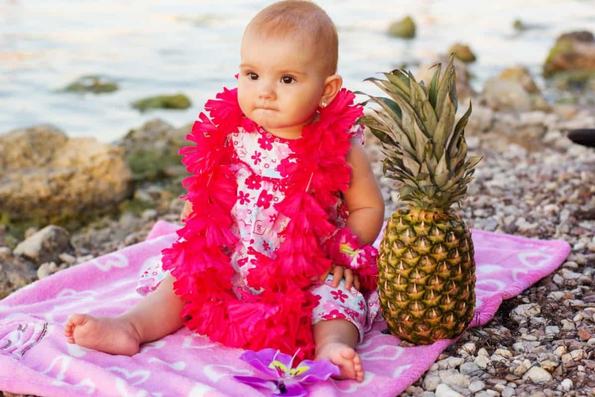 Little baby girl resting on the beach