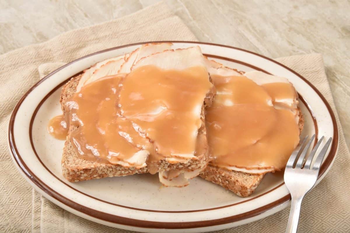 An open face turkey sandwich smothered in gravy