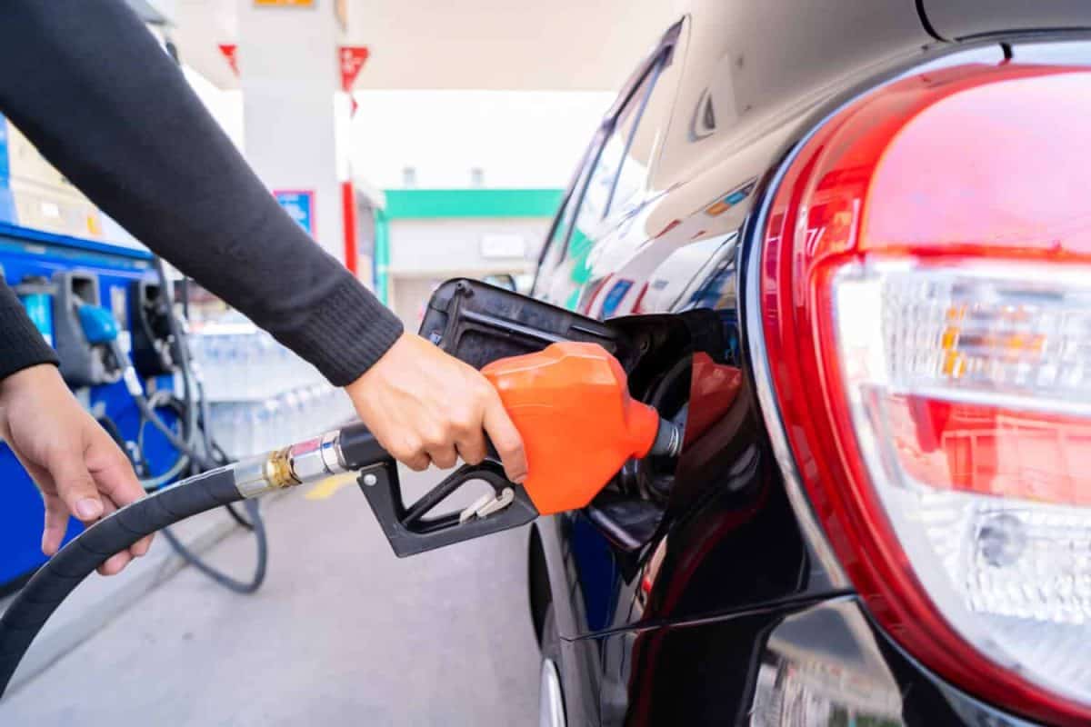 Refuel cars at the fuel pump. The driver hands, refuel and pump the car's gasoline with fuel at the petrol station. Car refueling at a gas station Gas station