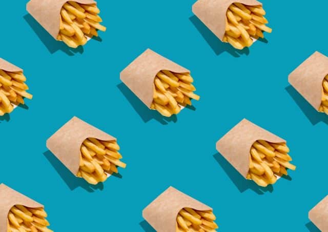 Lots Of French Fries In Paper Boxes Over Blue Background, Geometric Seamless Design, Creative Repeat Pattern, Top View