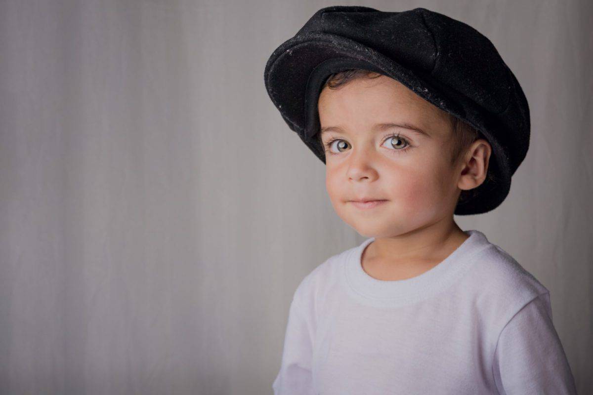 portrait of a little boy wearing an antique hat