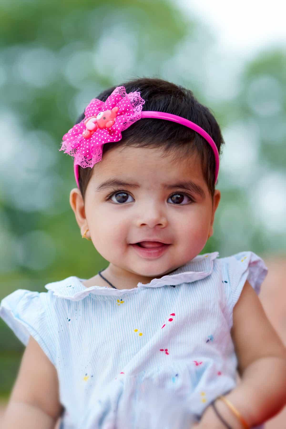 Indian baby girl child playing and giving smile