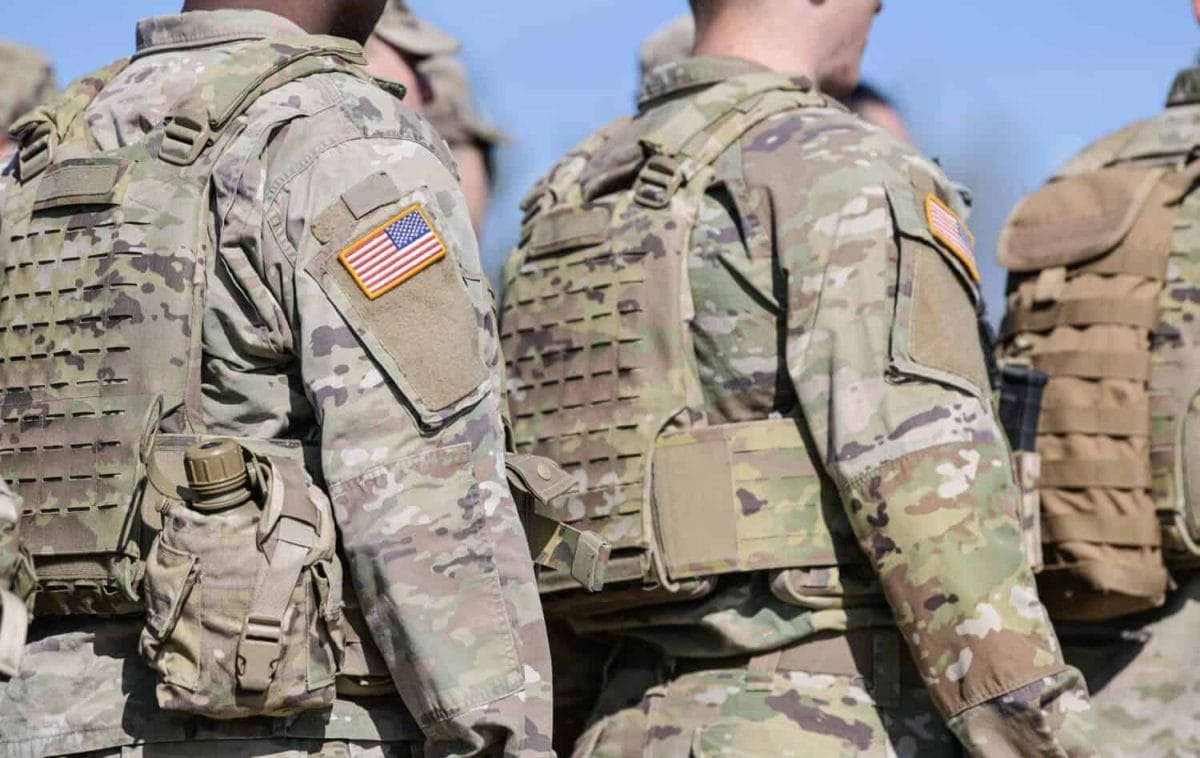 Detail view of the US Army uniform worn by soldiers in a military base. Flag of America on the uniform.