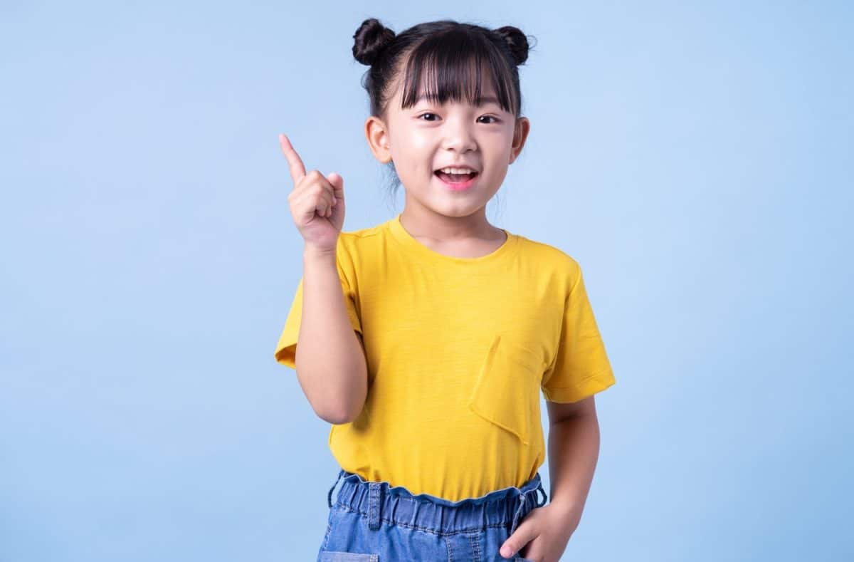 Image of Asian child posing on blue background