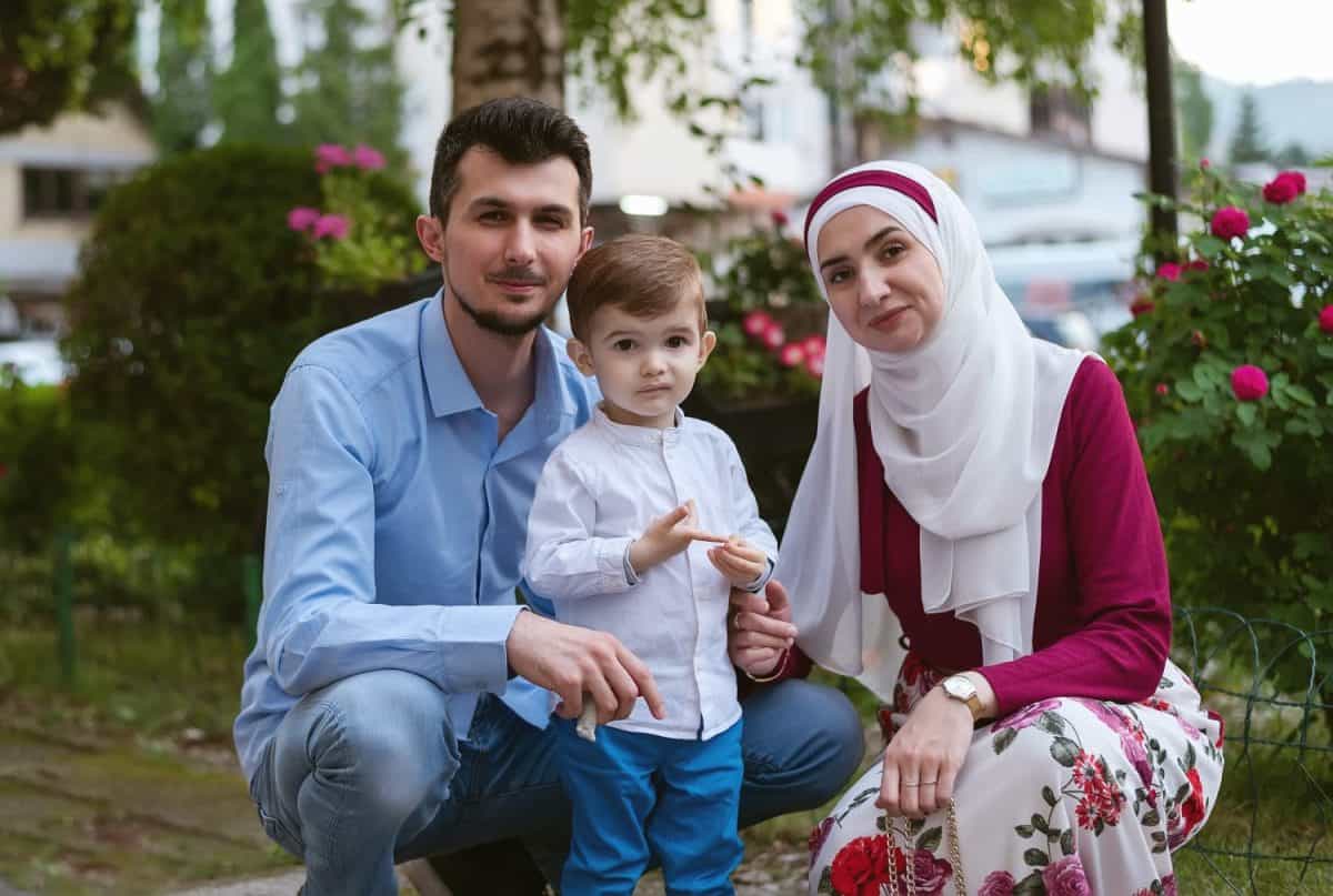 Portrait of a happy young muslim family in the summer garden.