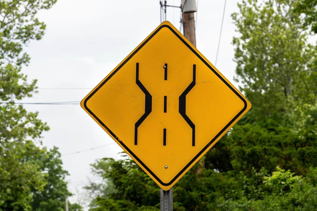 Approaching narrow bridge sign on roadside