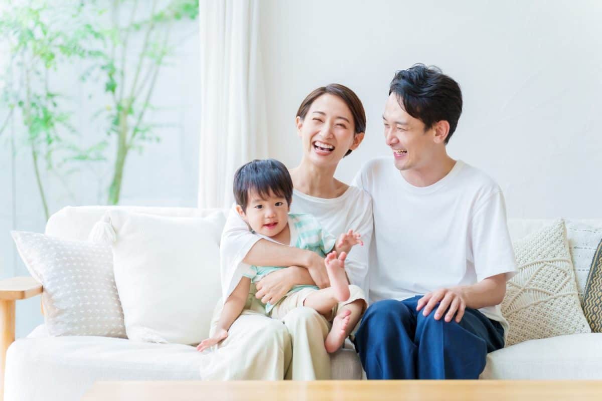 asian parents and boy relaxing in the living room