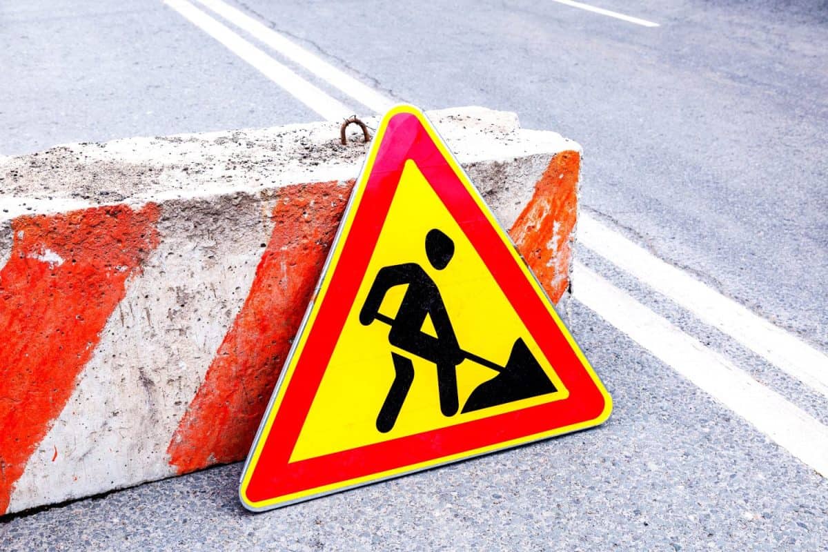 Road works sign at the city street. Carrying out construction and repair work in the city