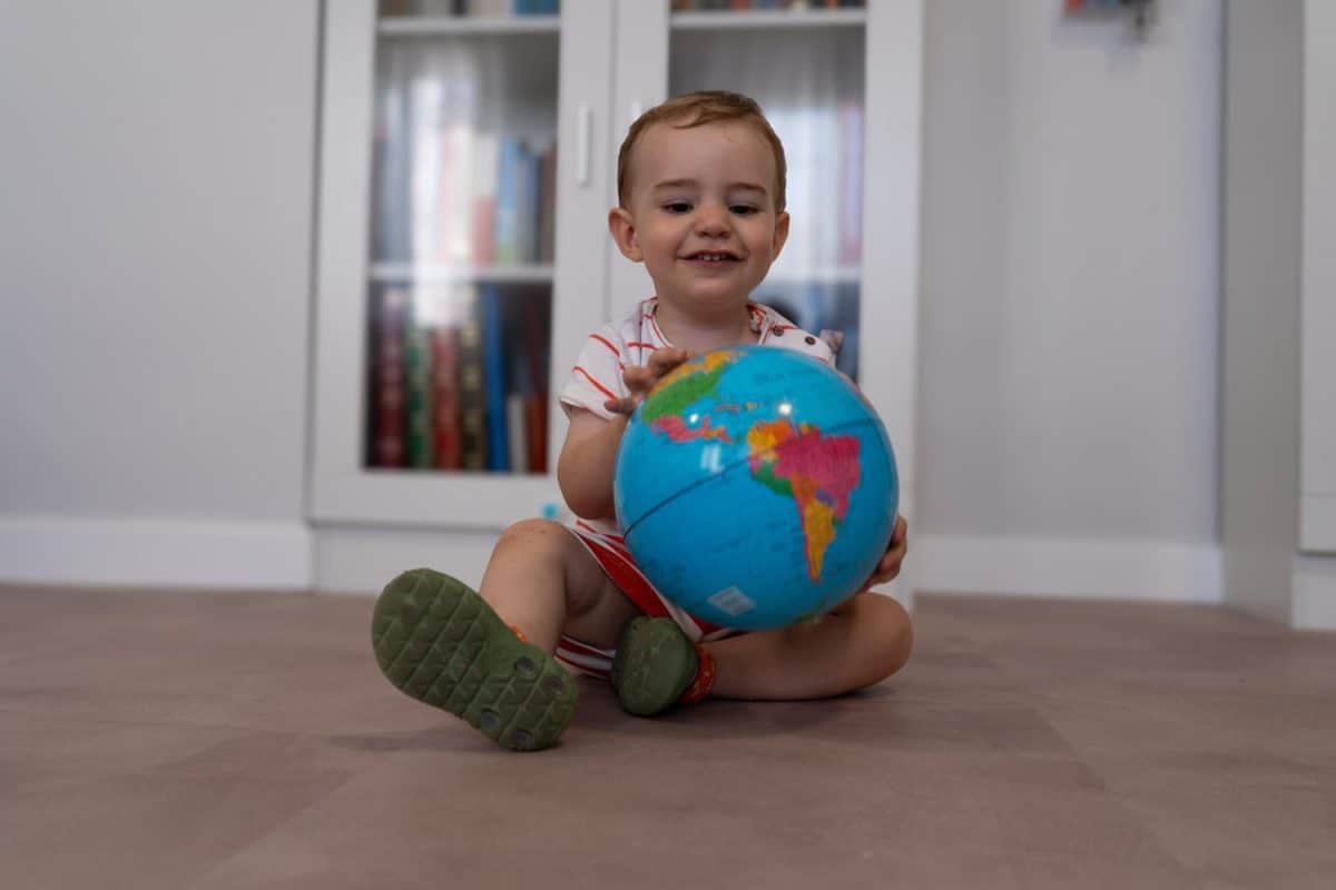 baby playing with the world ball