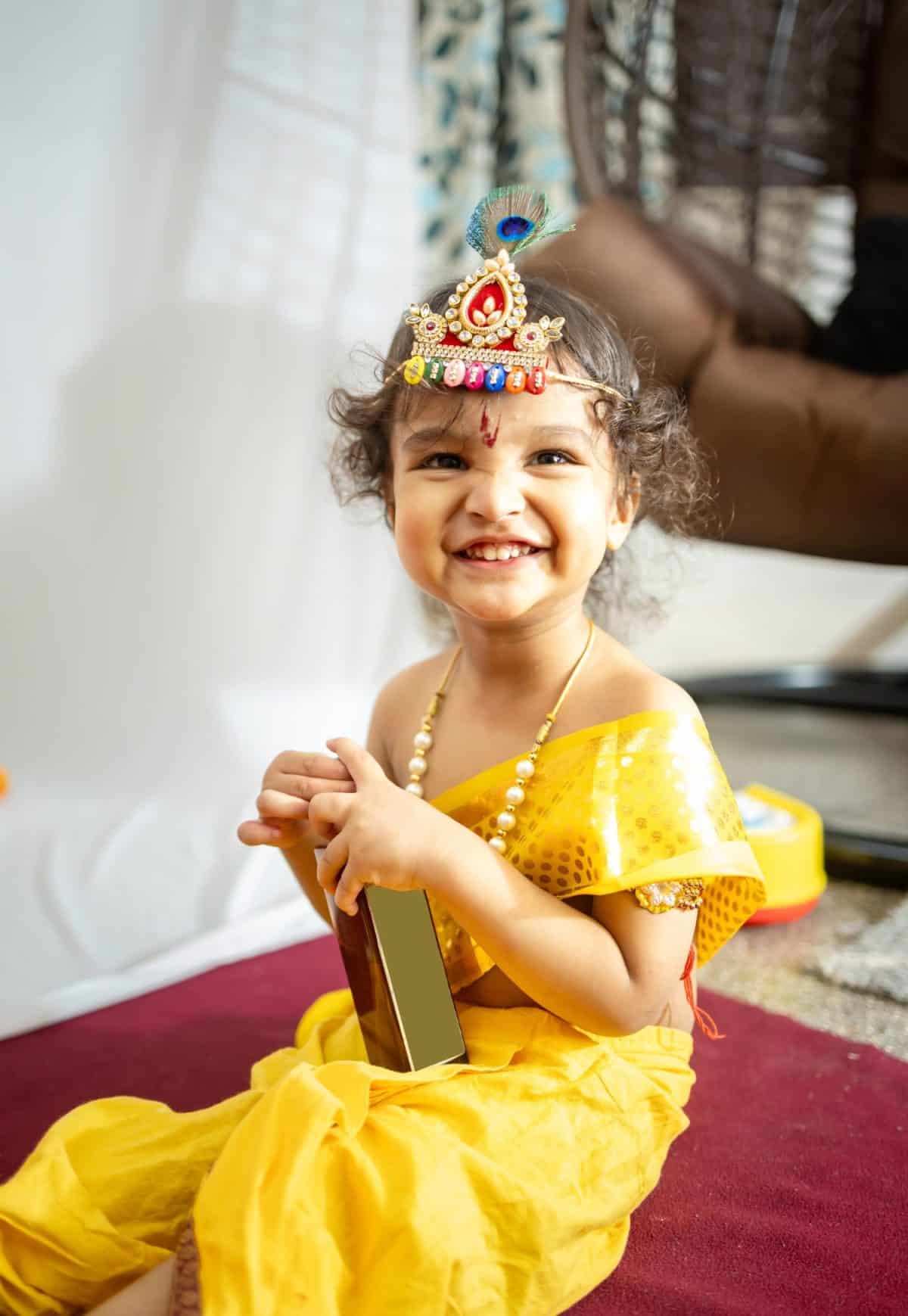 little indian baby boy in holy hindu god kirshna attire at indoor