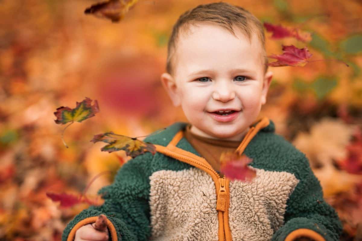 A baby boy having fun on Autumn Forest