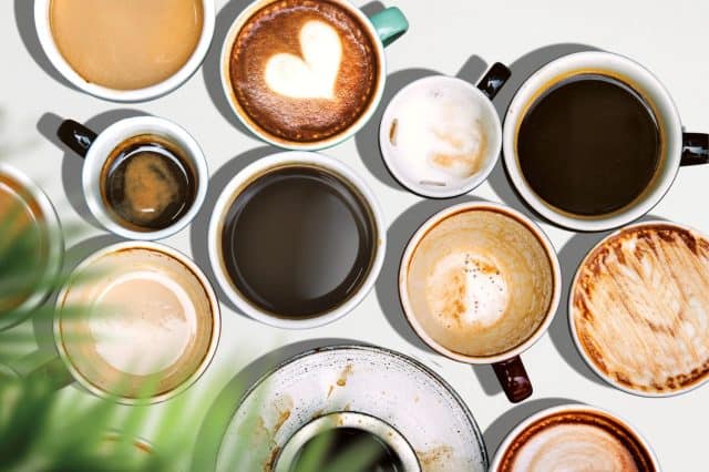 Top view of various of coffee cups, showcasing different coffee menu. Enjoy the rich coffee flavors in these artistic coffee cups.