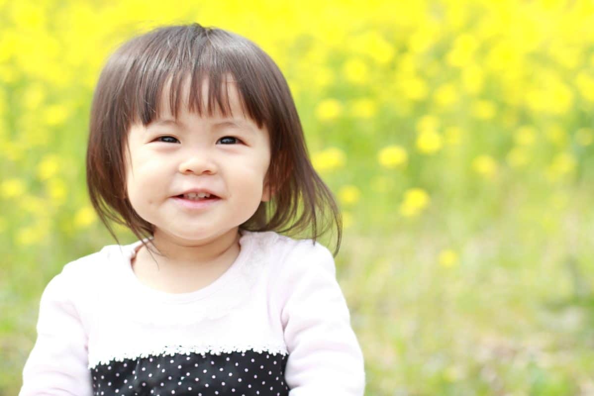 Japanese baby girl (1 year old) and yellow field mustard