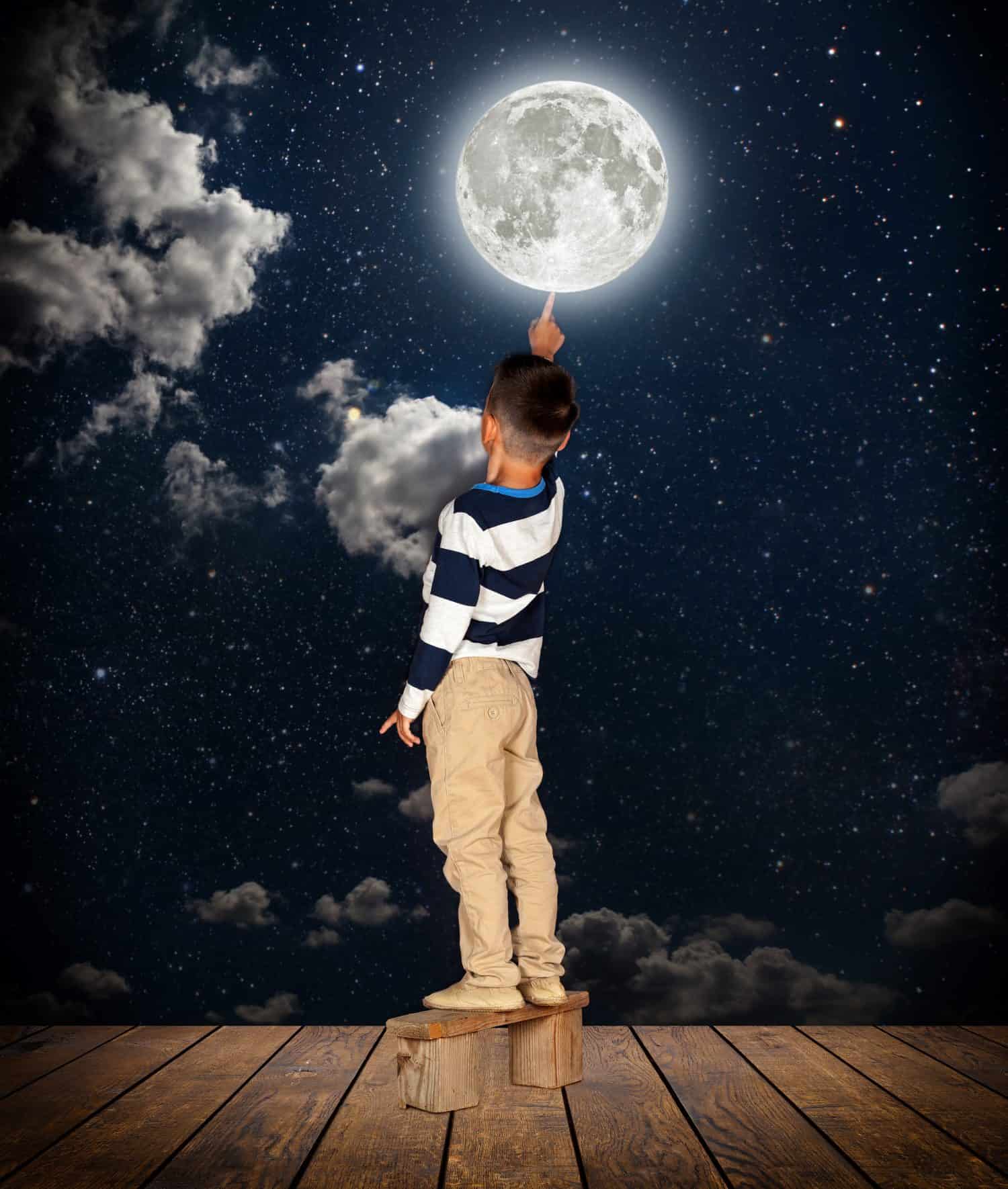 boy pulls out his finger to the moon