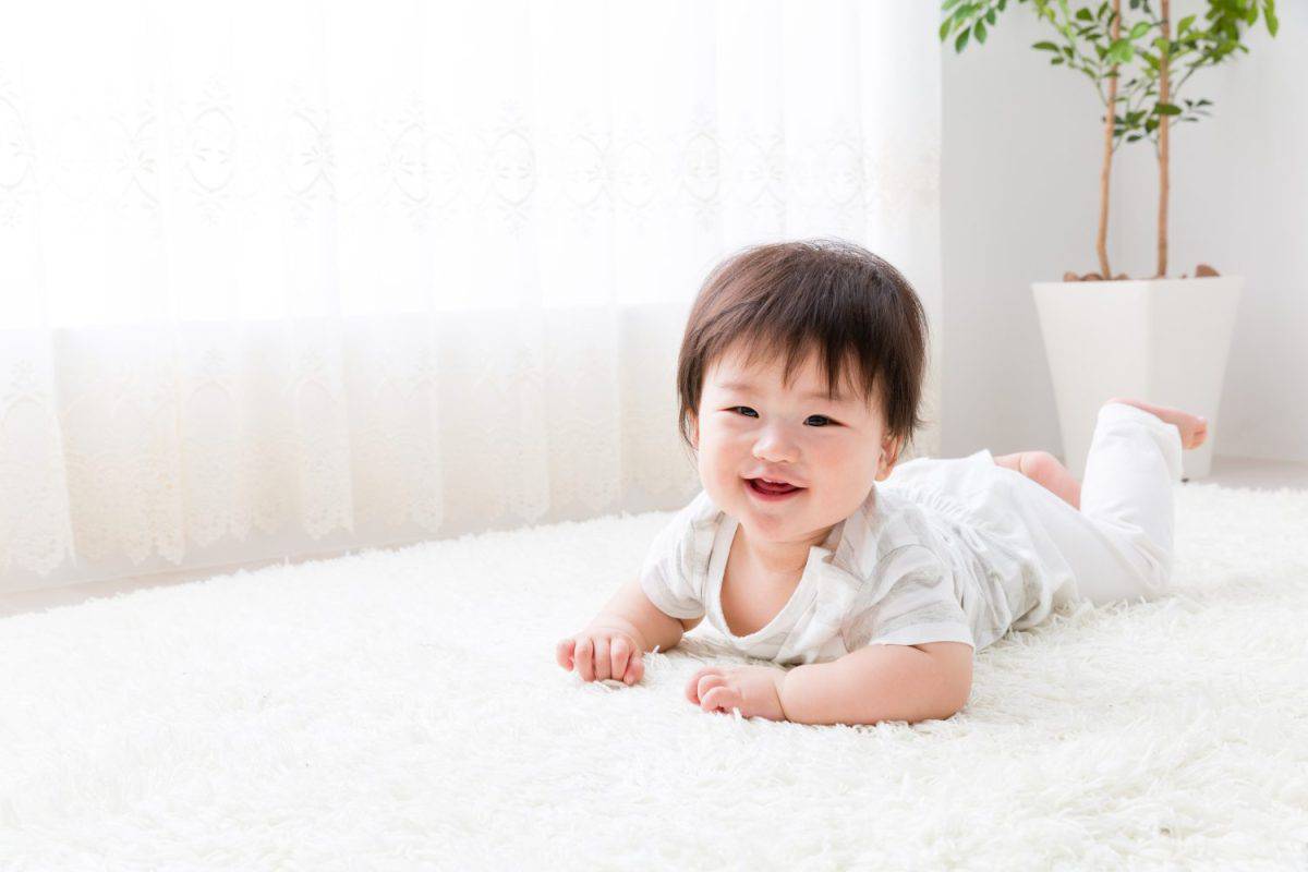 a asian baby on the carpet