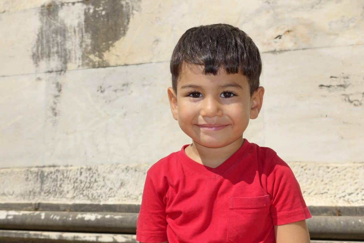 Portrait of smiling boy in the temple of Apollo.