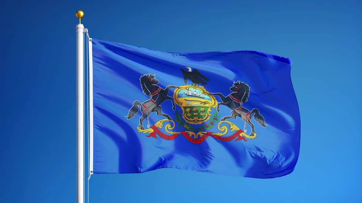 Pennsylvania (U.S. state) flag waving against clear blue sky, close up, isolated with clipping path mask alpha channel transparency, perfect for film, news, composition