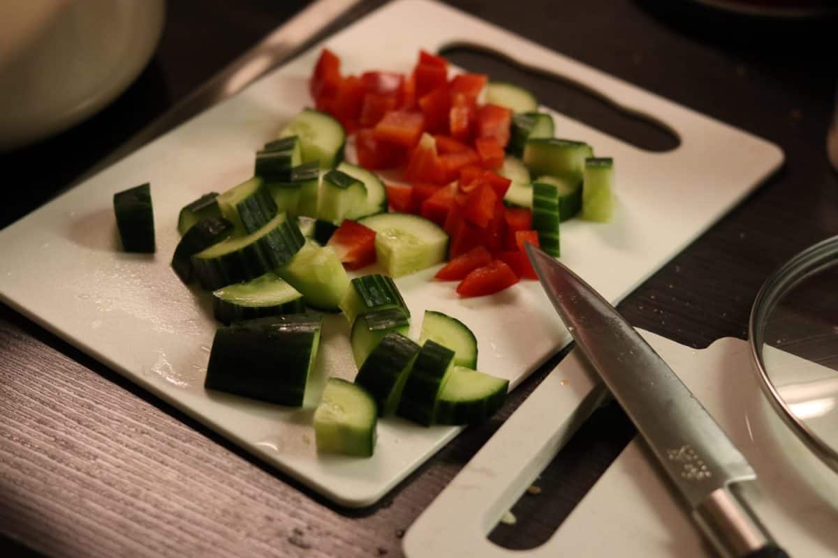 cooking meat casserole and making salad