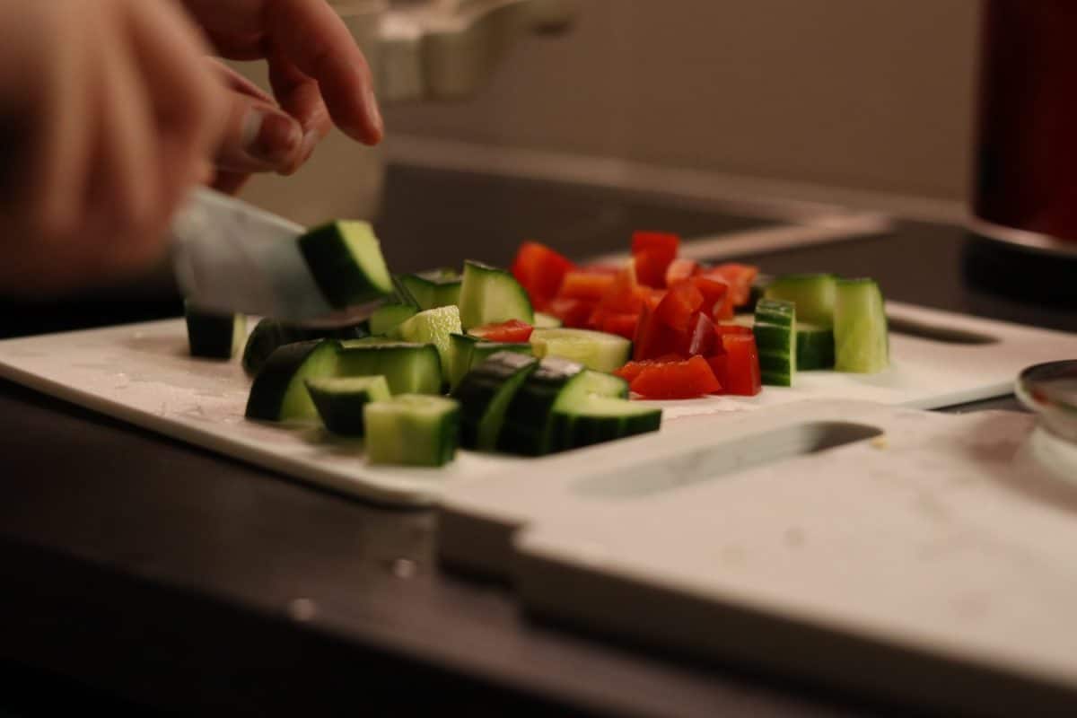 cooking meat casserole and making salad