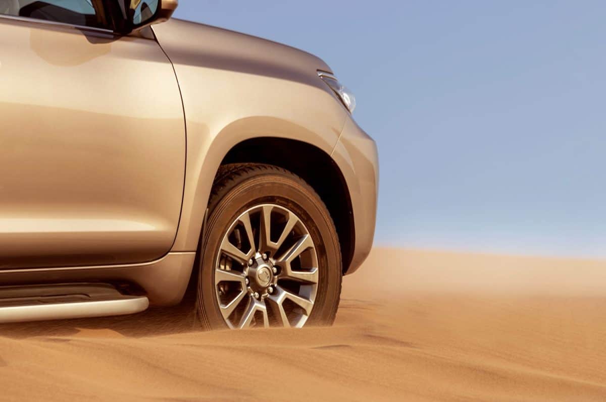 Close up of a golden car stuck in the sand in the Namib desert. Africa