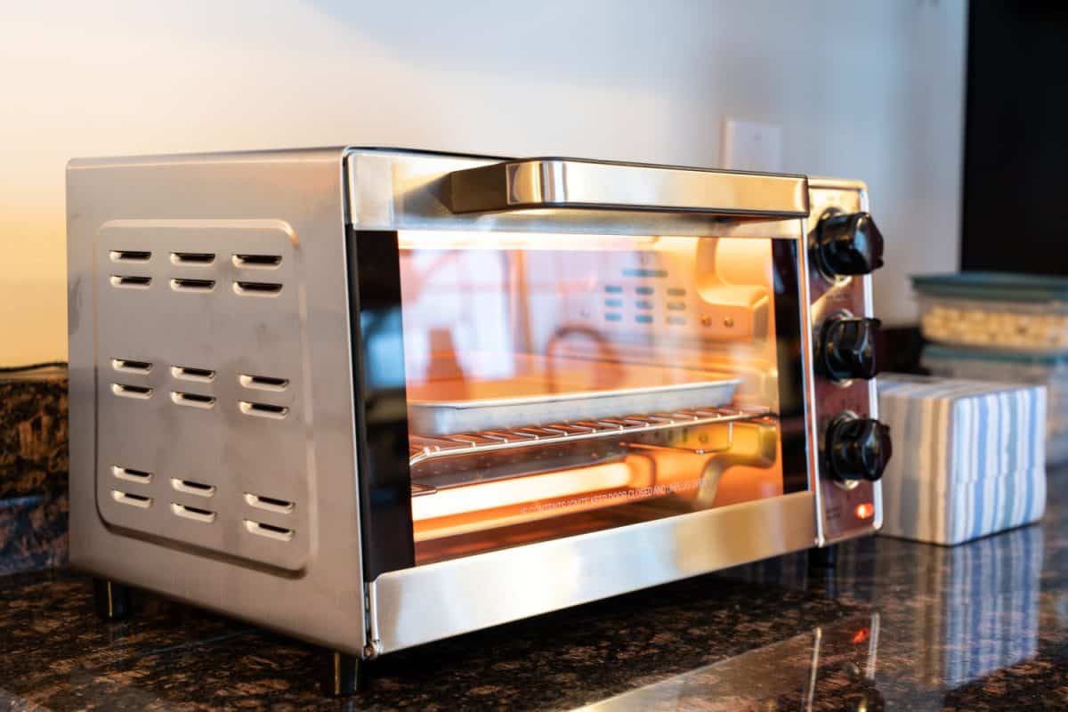 Stainless steel modern design toaster oven is on the granite kitchen countertop