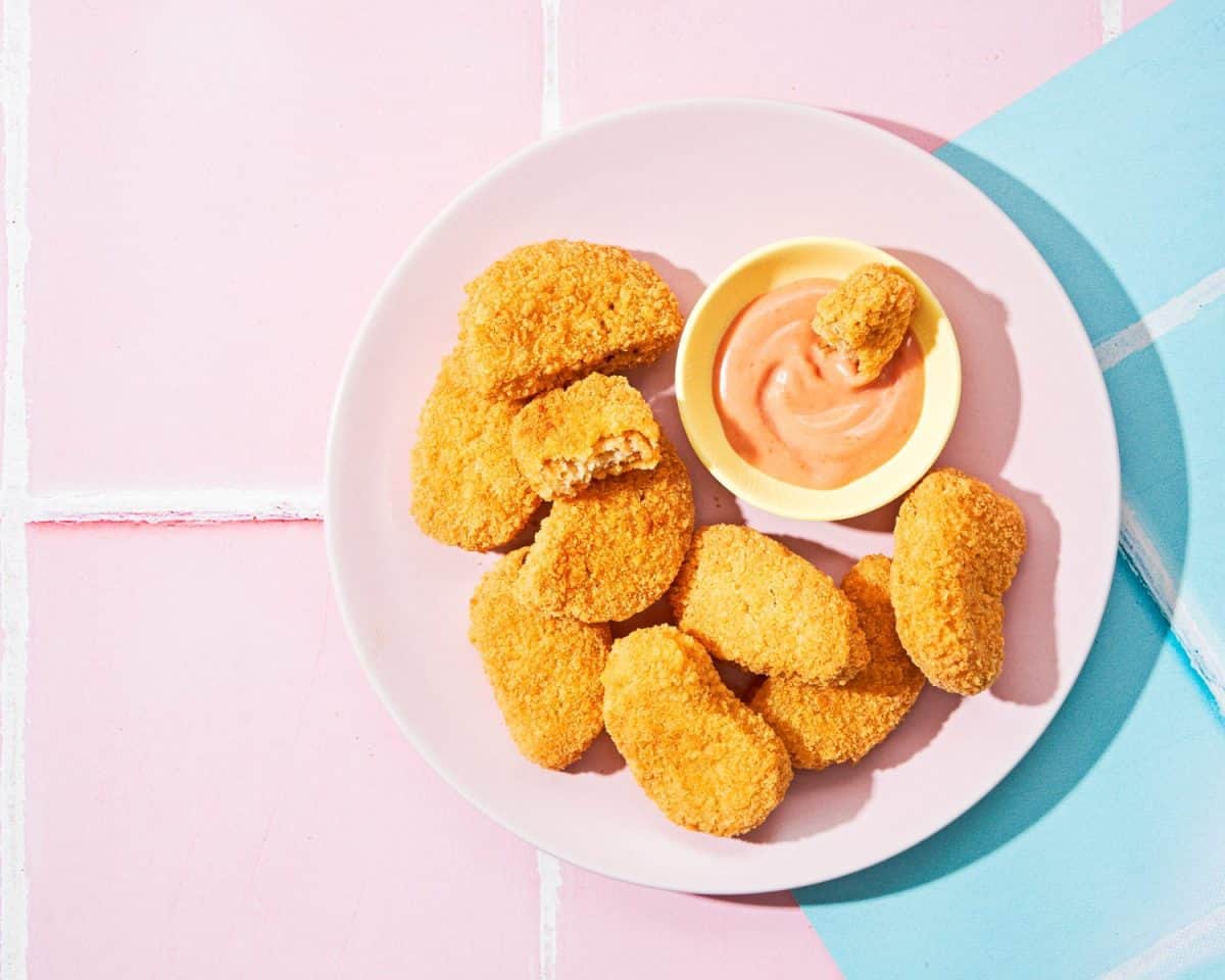 Vegetarian Nuggets with Vegan Dipping Sauce on pink pop art background with copy space. Hard light, shadows. Healthy Diet, Protein Vegetarian Meals concept, alternative meat products. Selective focus. Forget Chick-fil-A Sauce, Americans Go Crazy for These 16 Condiments