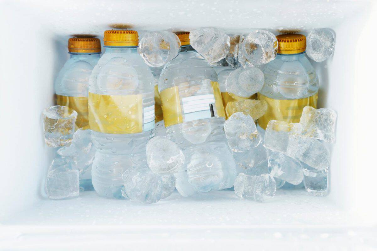 Top view of a picnic fridge with bottles of water and ice cubes. Holiday, vacation and refreshment concept. 8 Coolers That Are Cheaper and Just as Good as a Yeti