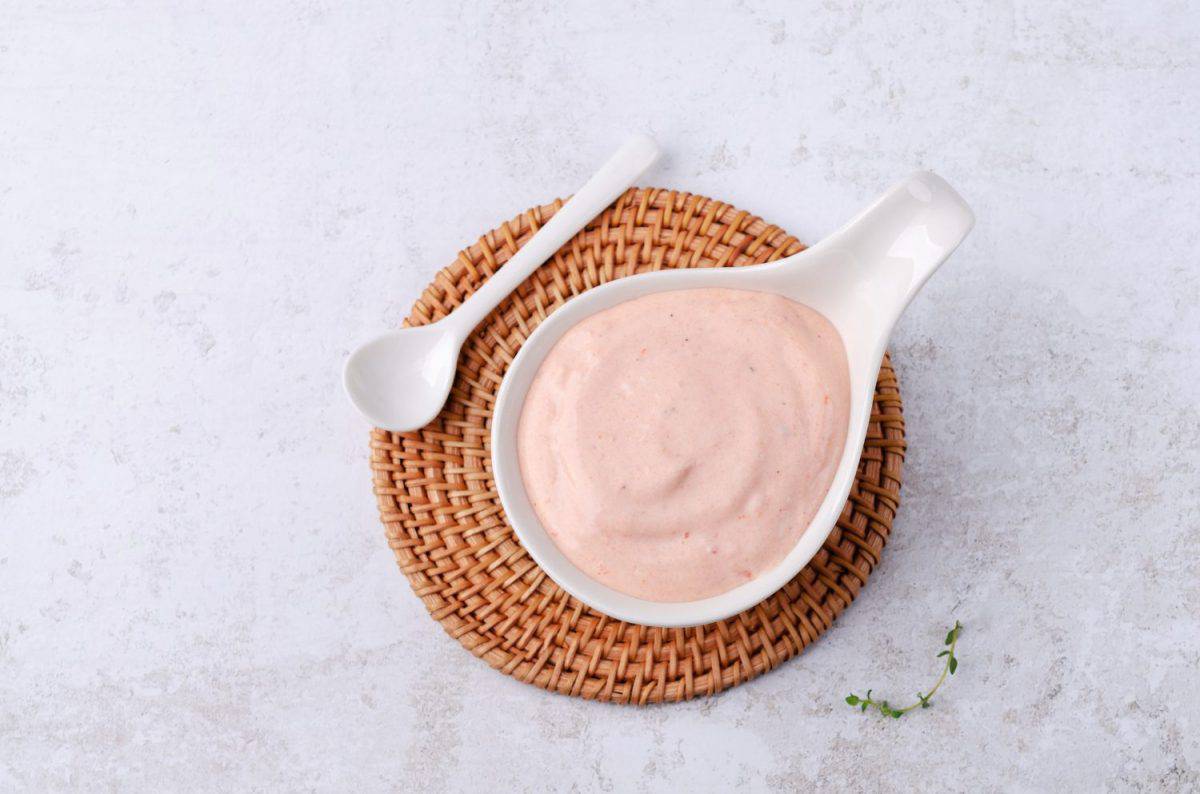 Pink dip sauce in a ceramic dish on a light gray background. Top view. Forget Chick-fil-A Sauce, Americans Go Crazy for These 16 Condiments