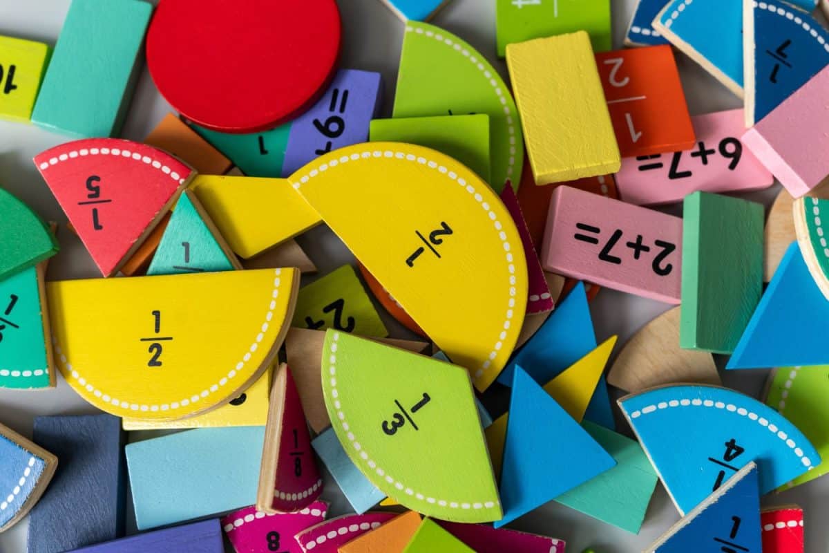 back to school background. colorful math fractions and notebook on the table. Mathematics and geometry in preschool and school