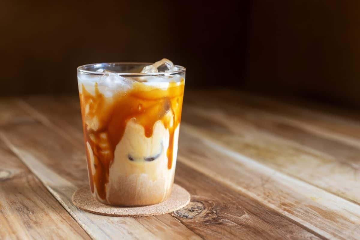 ice caramel macchiato coffee on wooden table.