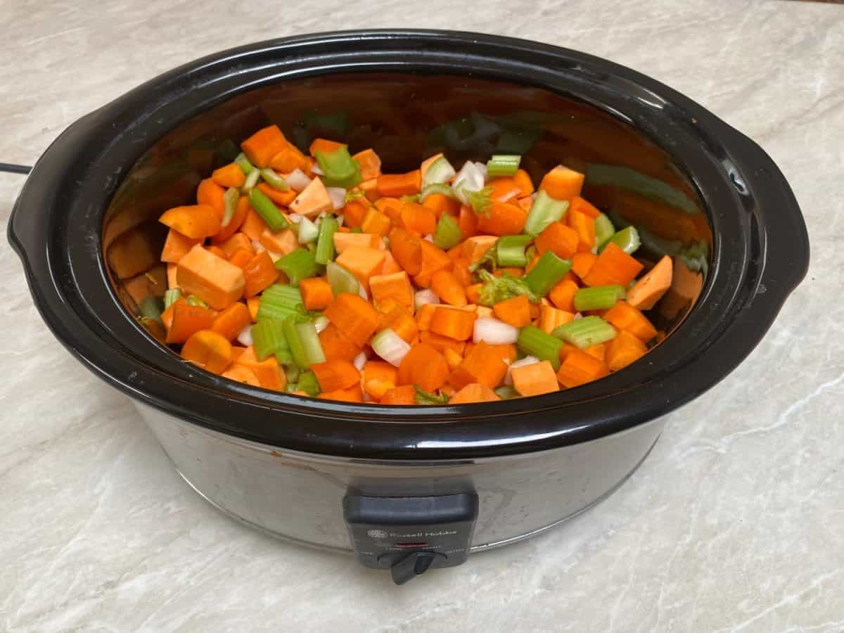 Vegetable soup in oval slow cooker with carrots sweet potato and celery sitting on kitchen benchThe Instant Pot Was My Kitchen Hero, But These 16 Appliances Are Superior