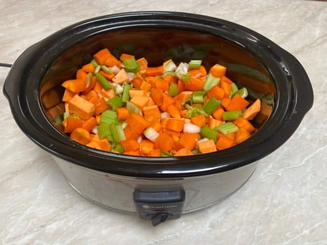 Vegetable soup in oval slow cooker with carrots sweet potato and celery sitting on kitchen bench The Instant Pot Was My Kitchen Hero, But These 16 Appliances Are Superior