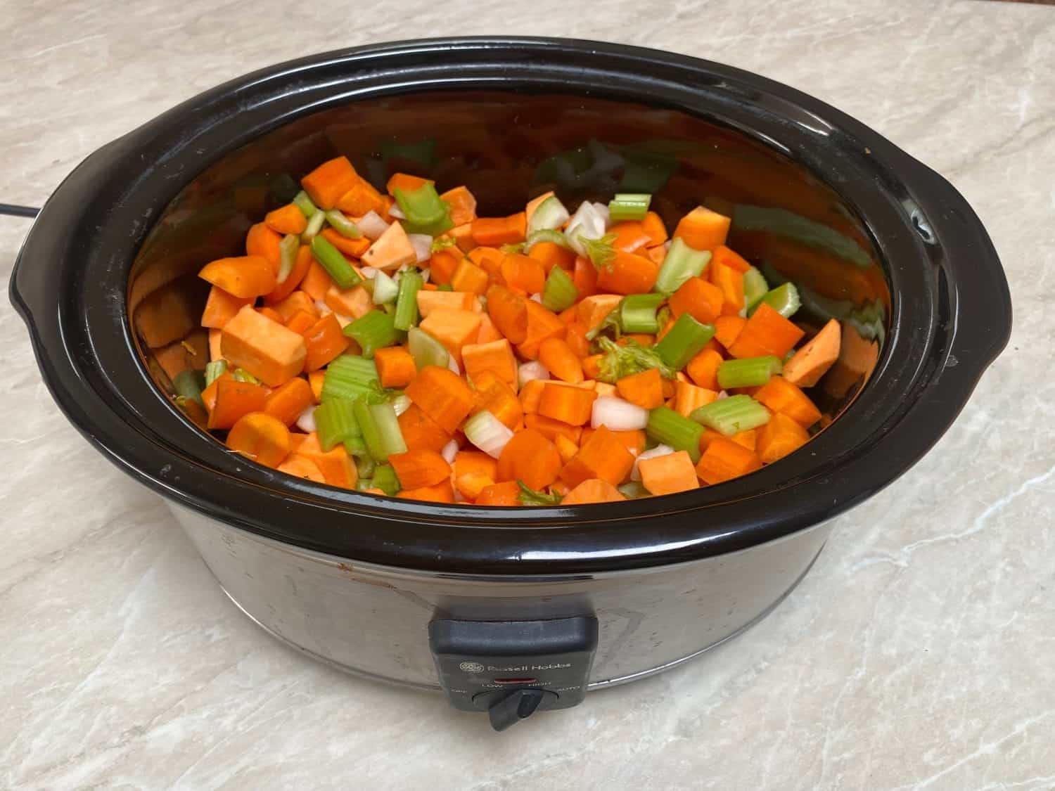 Vegetable soup in oval slow cooker with carrots sweet potato and celery sitting on kitchen bench The Instant Pot Was My Kitchen Hero, But These 16 Appliances Are Superior