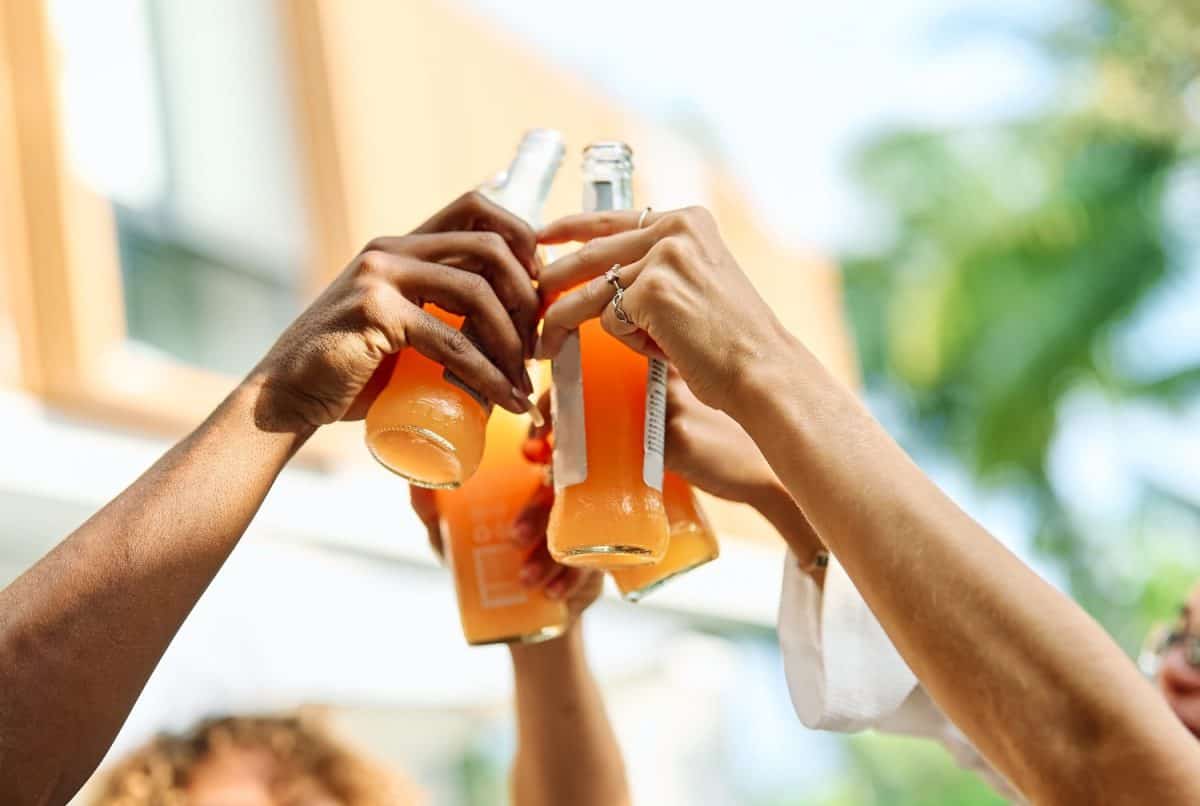 Multiracial friends toasting beer and cocktail bottle at pool party, Young people having fun together outside , Food and beverage life style concept with guys and girls drinking alcohol on summer