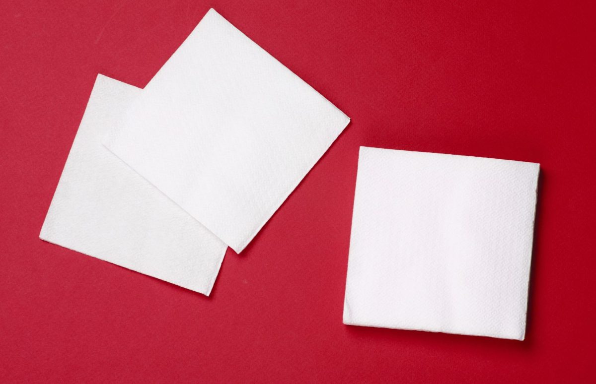 White paper napkins on a red background. Top view