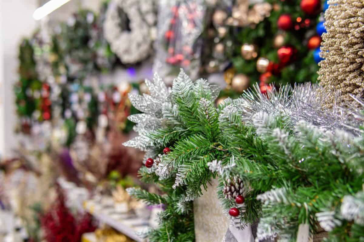 Sale of Christmas decorations in the store. Christmas tree toys, Christmas wreaths and tinsel