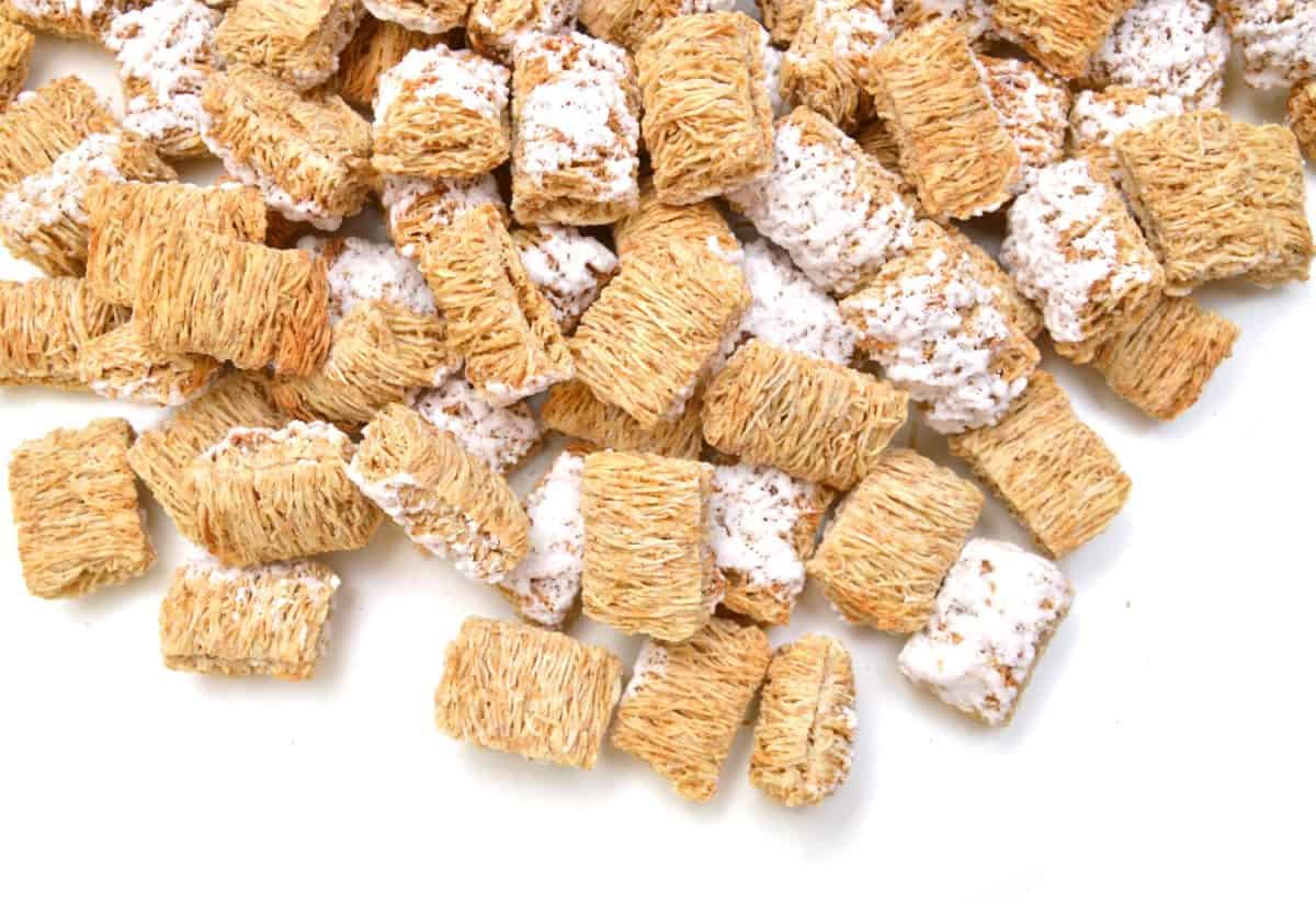 Breakfast setting with frosted wheat cereal on white background