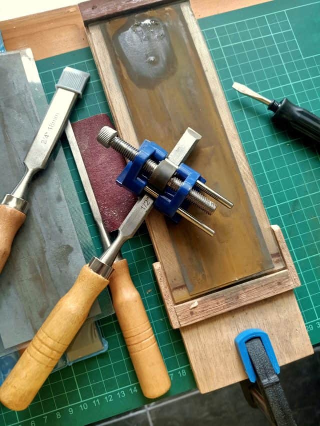 Sharpening chisels using sandpaper and honing guide. Chisel is one of the wood working equipment