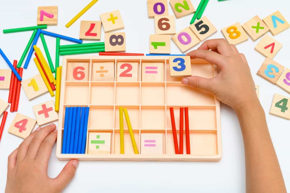 kid doing division equation using counting rods