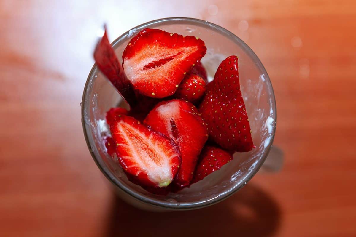 Fresh chopped strawberry . Berries in the cup