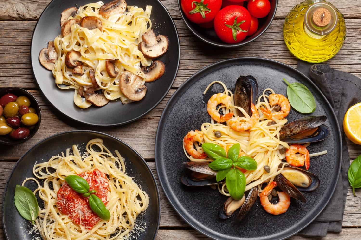 Various Italian pasta. Seafood, mushroom and tomato sauce pasta, spaghetti bolognese. Top view flat lay