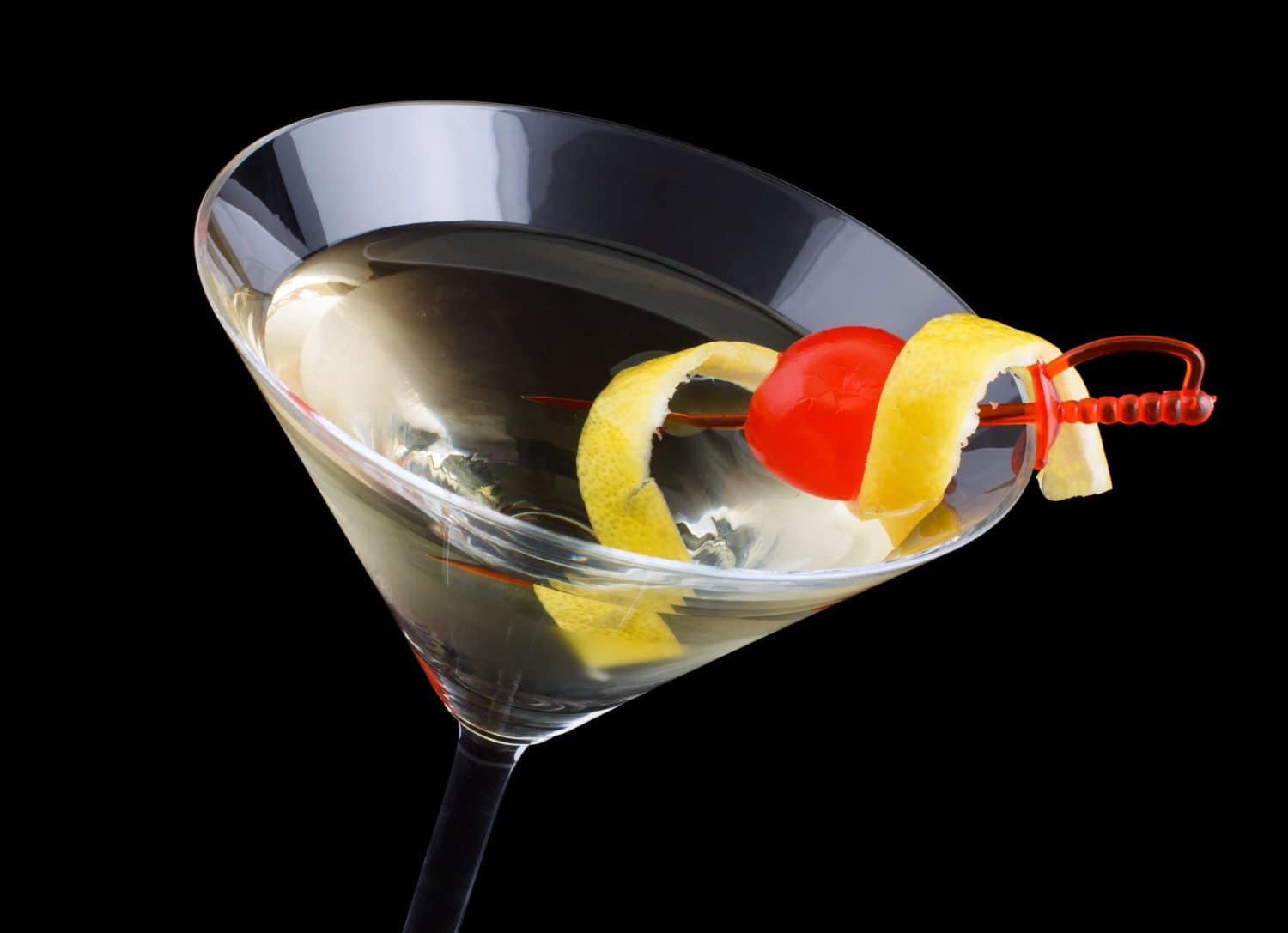 Tuxedo cocktail, consisting of Old Tom Gin, dry vermouth, maraschino liqueur, absinthe and orange bitters, garnished with a maraschino cherry and a lemon twist