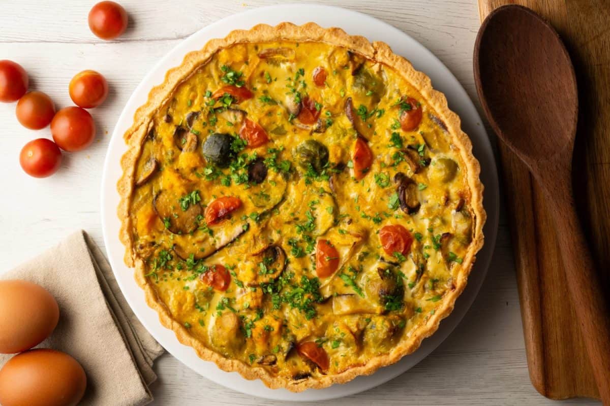 French quiche with fall vegetables such as brussels sprouts, sweet potato, and mushrooms.