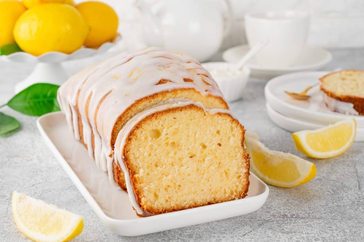 Lemon loaf cake with sugar icing on a white plate on a stone background. Copy spaceHarsh Realities That Made Me Reevaluate My Love for Starbucks