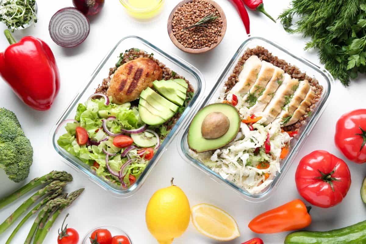 Healthy diet. Different meals in glass containers and products on white background, flat lay