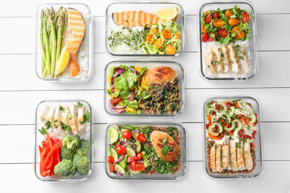 Healthy meal. Containers with different products on white wooden table, flat lay