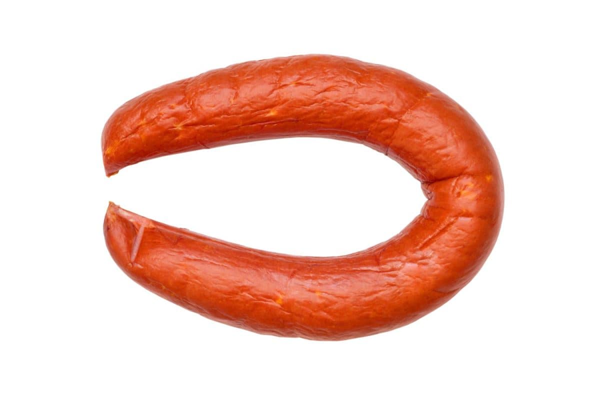 A ring of fresh meat sausage isolated on a white background. Close-up of smoked sausage. I Used to Only Eat Boar's Head Deli Meat, But These 8 Brands Are Just as Good